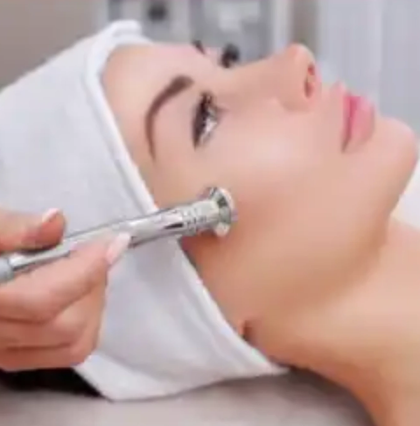 A woman getting her face waxed at the spa