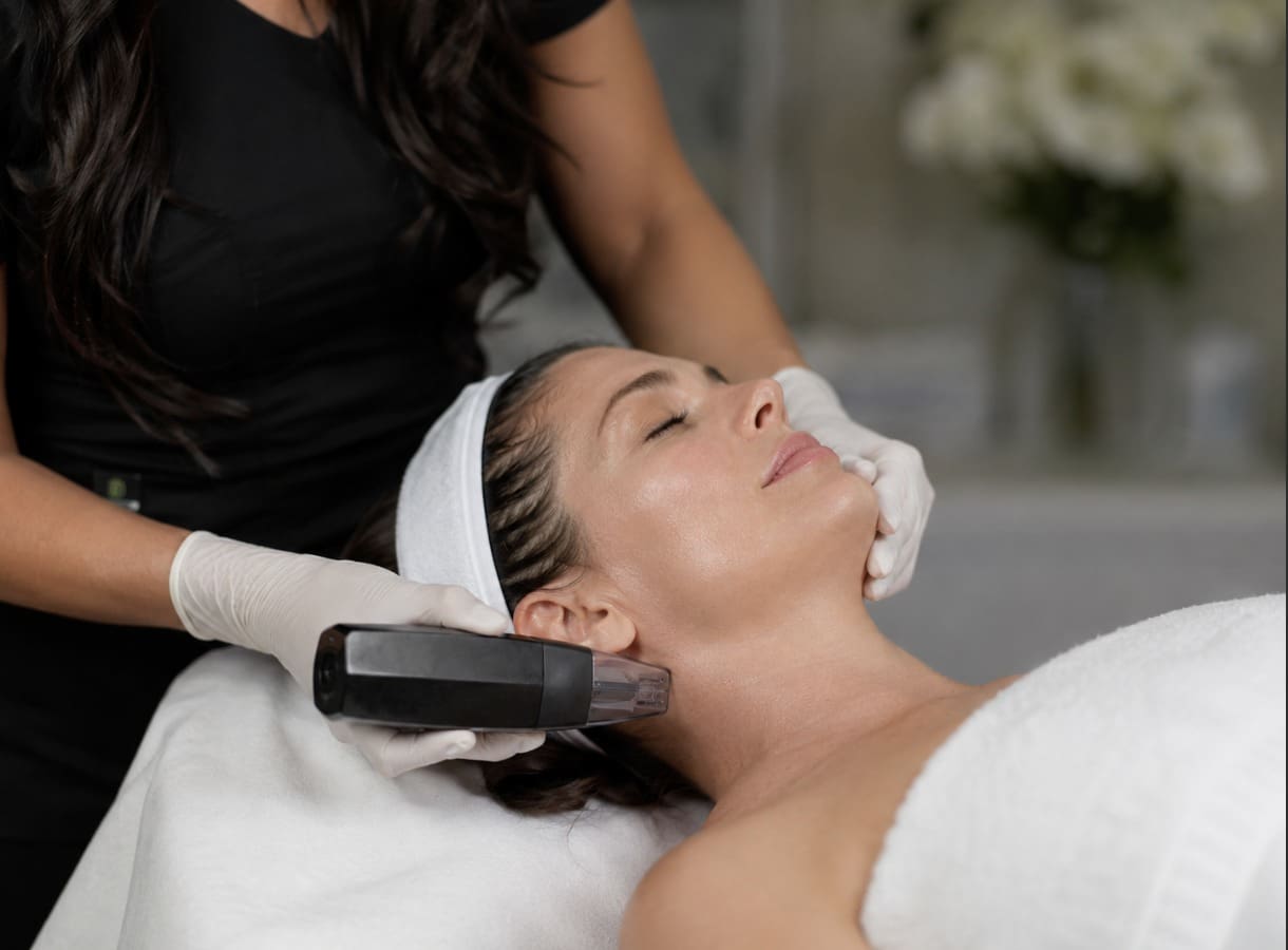 Provider performing a Morpheus8 RF microneedling treatment on a relaxed client