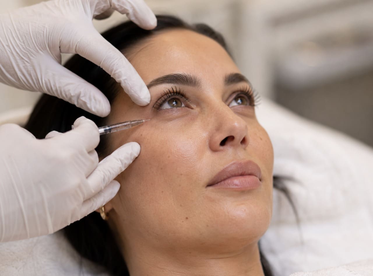 Certified nurse injector preparing an E-Z Gel treatment for a client