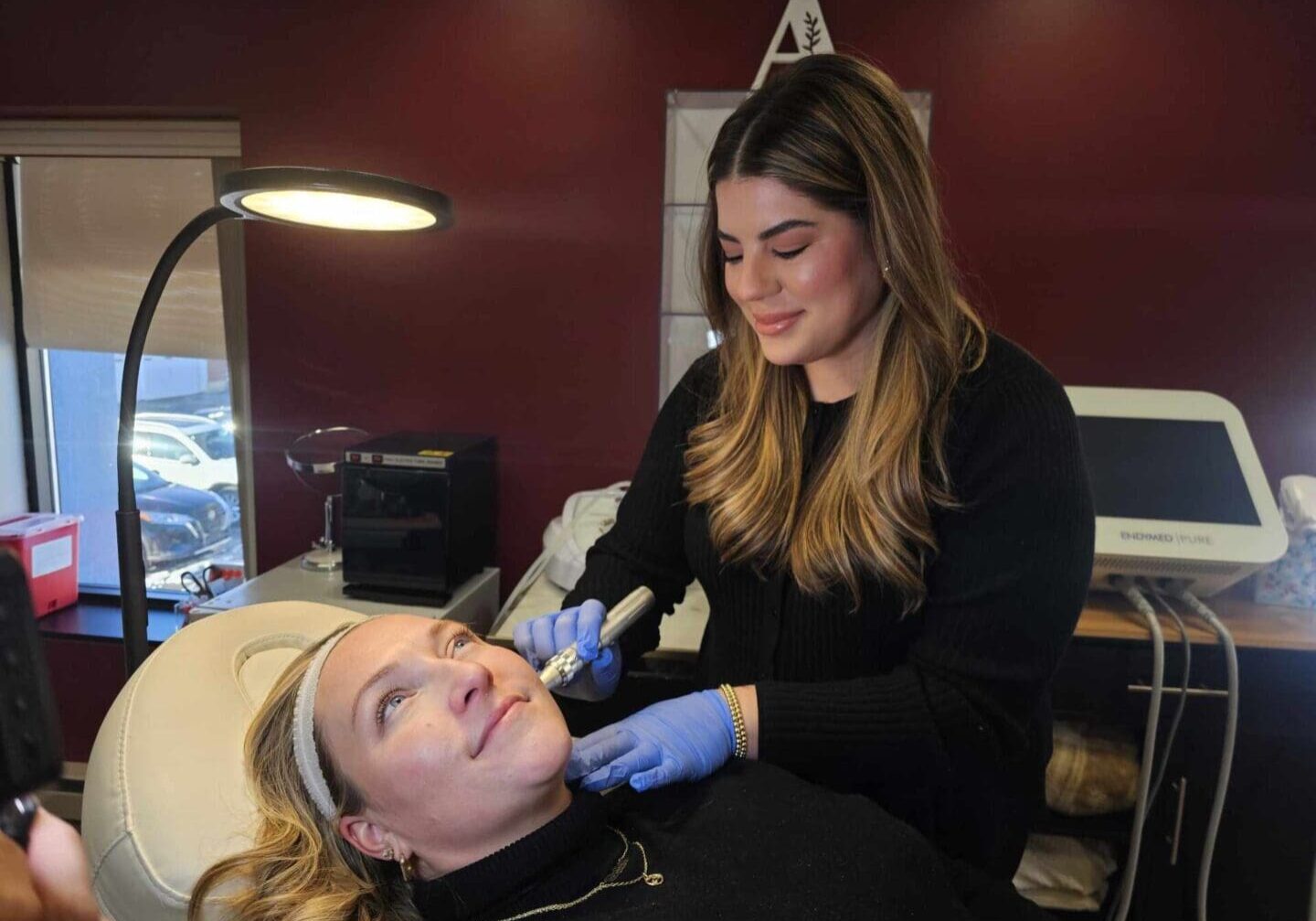 Woman receiving skincare treatment in clinic.
